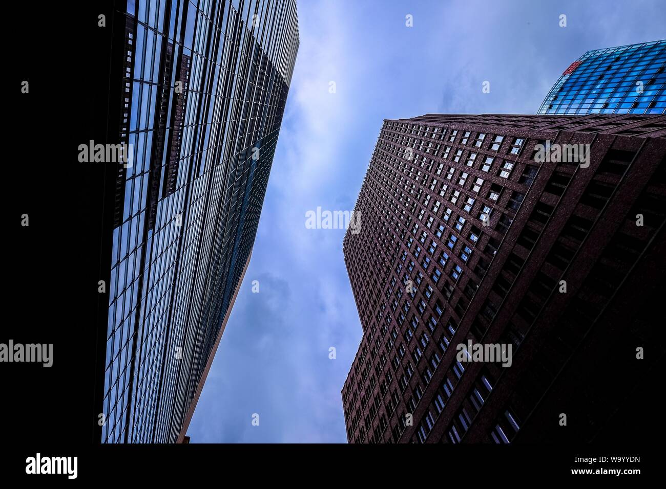 Low angle shot of tall business buildings under a cloudy sky Stock ...