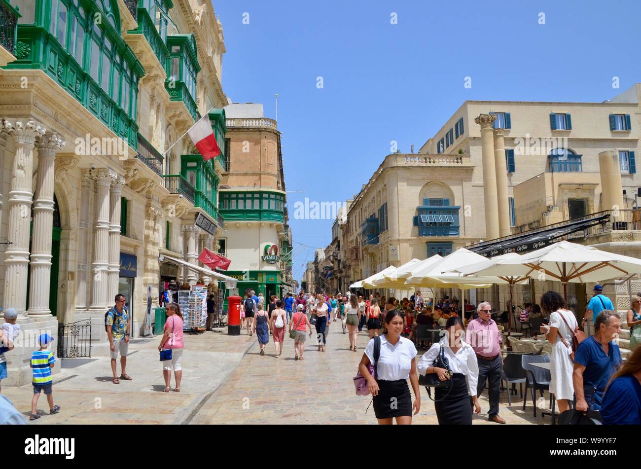 shops and cafes and tourists on republic street valletta malta Stock