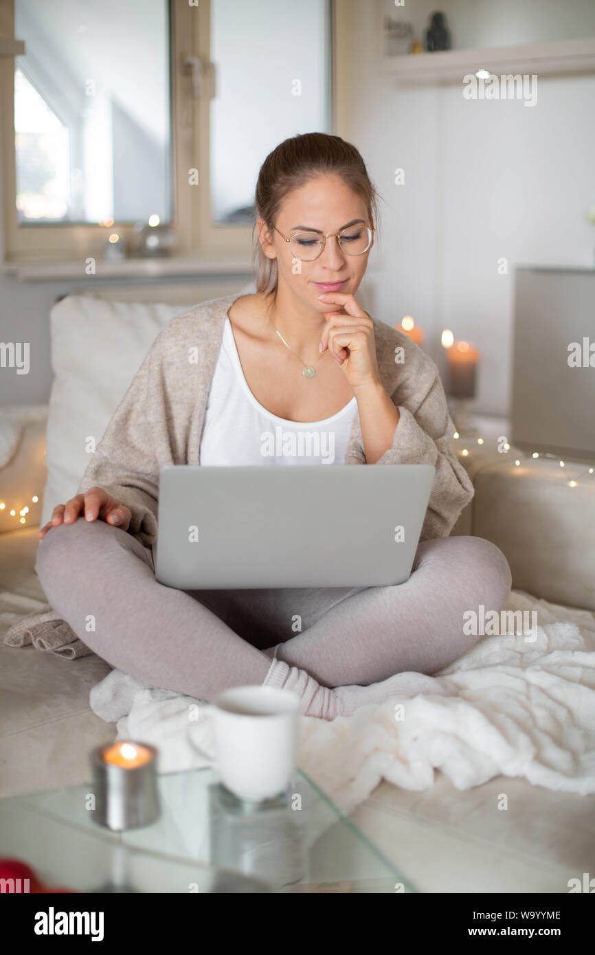 beautiful happy woman with blond hair surfing the net/homeoffice Stock Photo