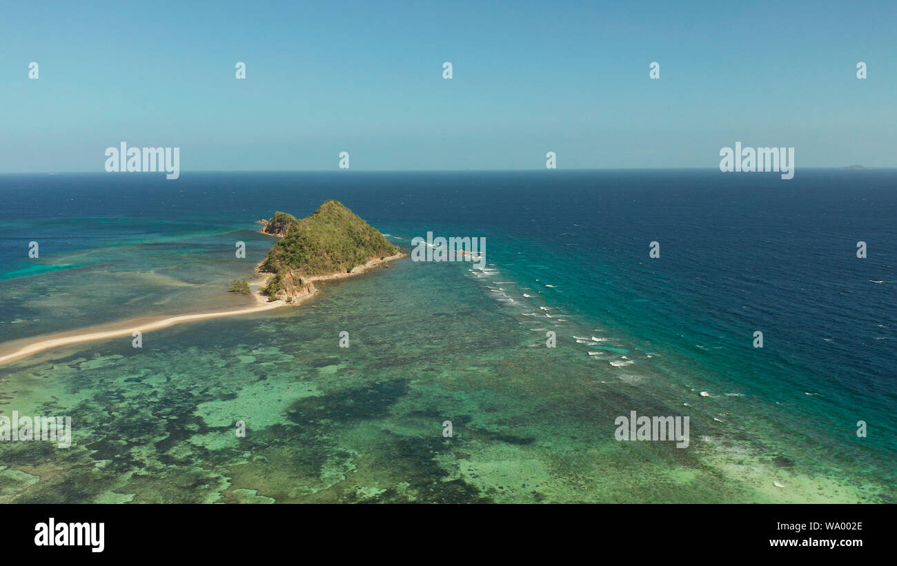 aerial view tropical island in blue lagoon, coral reef and sandy beach ...