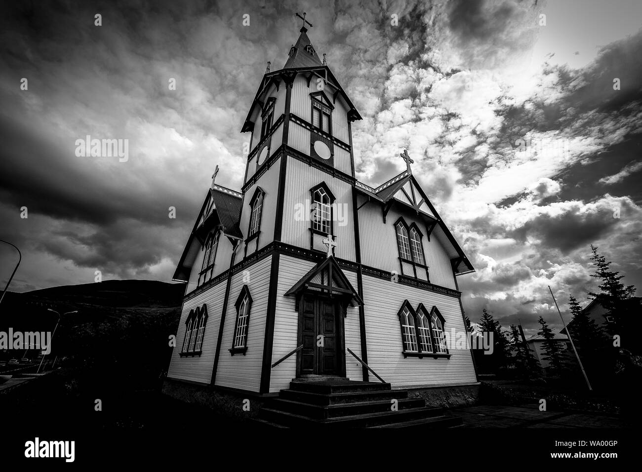 Low angle shot of a church under a cloudy sky in black and white Stock ...