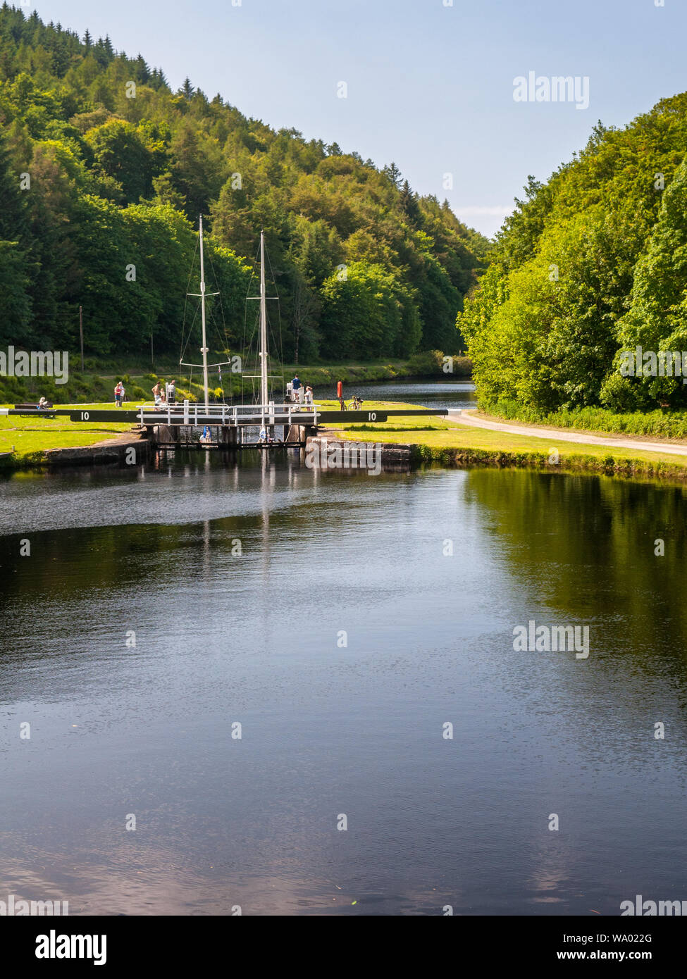 Crinan, Scotland, UK  - June 3, 2011: A pair of small sail boats pass through Dunardry Lock No. 10 on the Crinan Canal in Argyll in the West Highlands Stock Photo