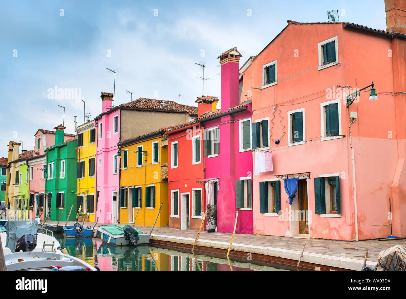 Venice landmark, Burano island with colorful houses and boats, Italy Stock Photo