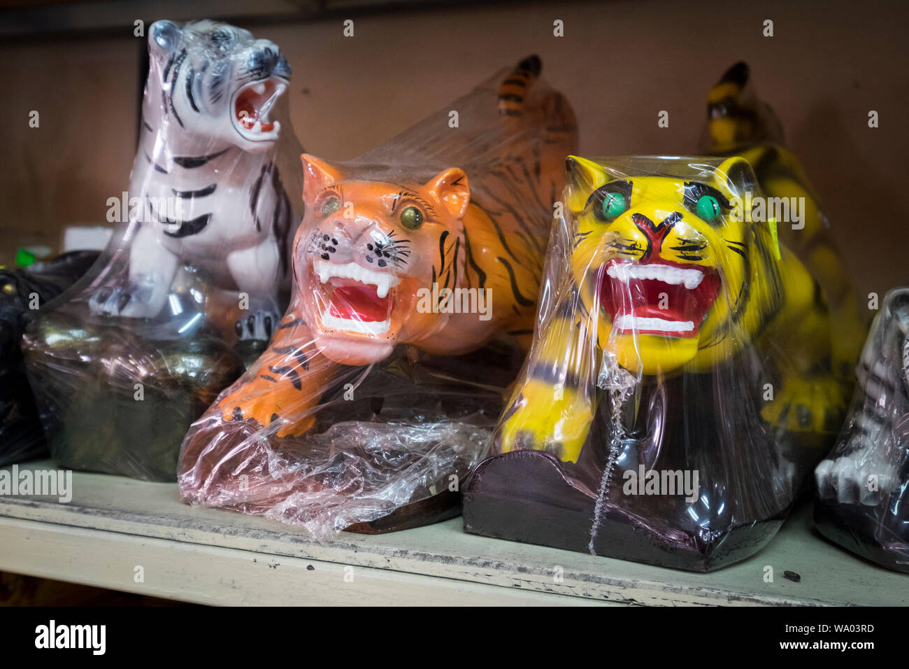 Various tiger figures, used as Buddhist offerings. At a religious shop in Alor Setar, Kedah, Malaysia. Stock Photo