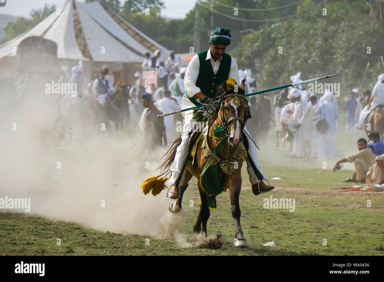 Tent Pegging horse rider missing target at cultural festival Pakistan. Stock Photo