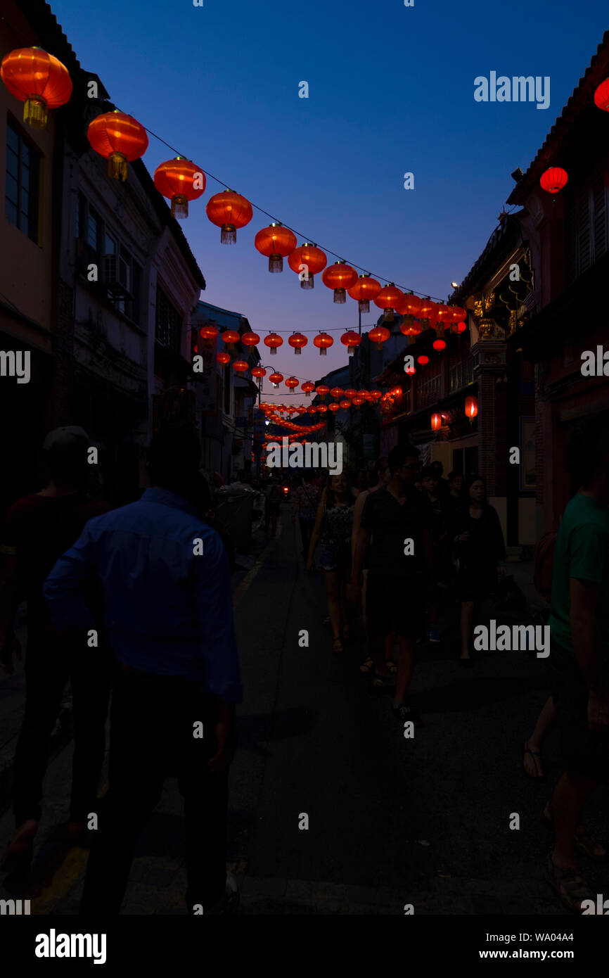 Decorative hanging red Chinese lantern strands cross the streets in George Town, Penang, Malaysia. Stock Photo