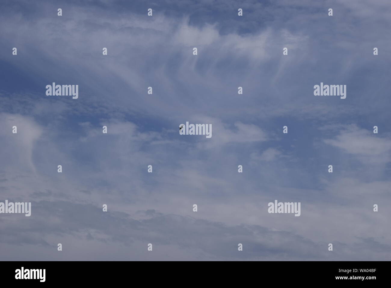 Beautiful white fluffy cloud formations on a deep blue sky Stock Photo
