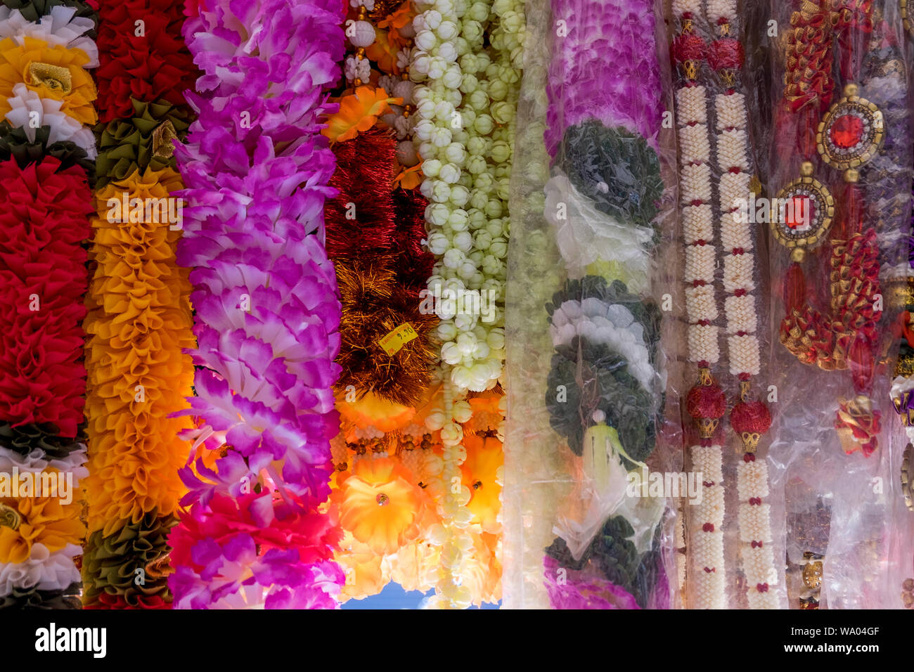 Plastic flower strands are for sale at an Indian Hindu religious items ...