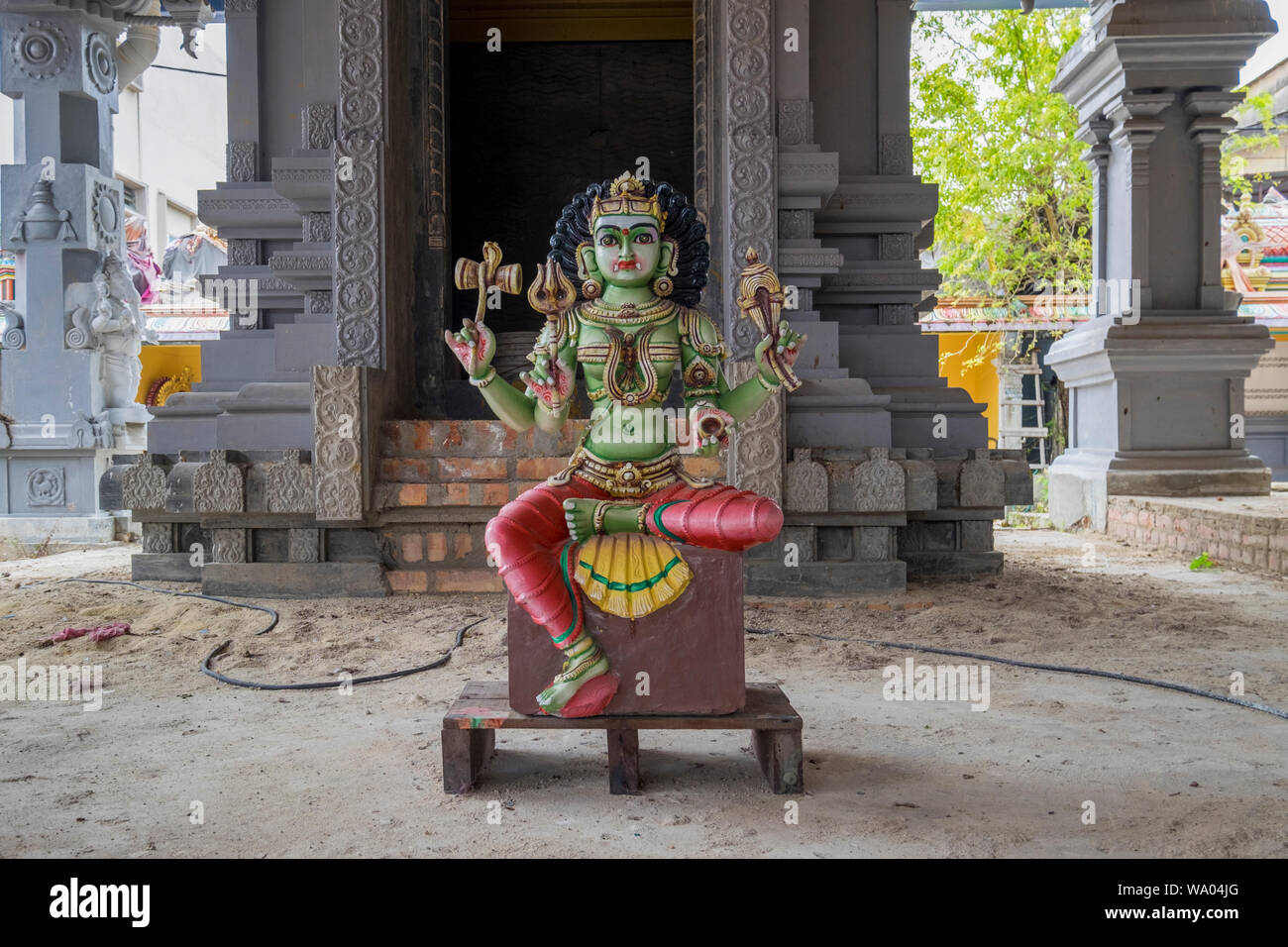 A renovated Hindu God statue sits waiting to be placed at a Dravidian style Hindu temple in Port Dickson, Malaysia. Stock Photo