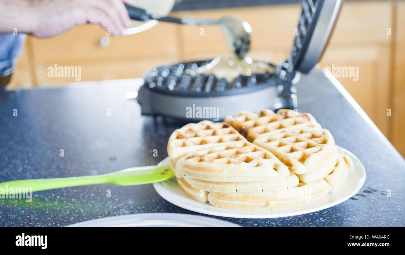 Making homemade waffles in an electric waffle maker Stock Photo Alamy