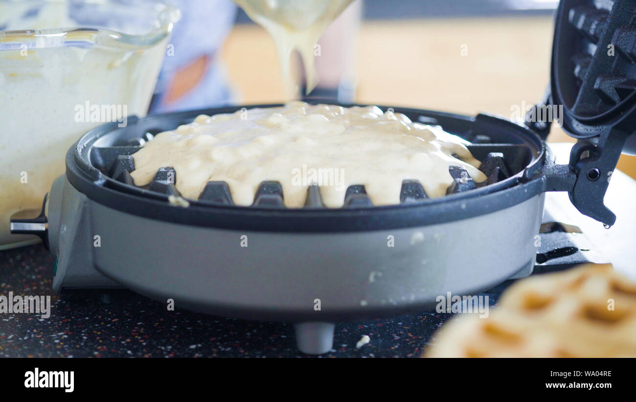 Making homemade waffles in an electric waffle maker Stock Photo Alamy