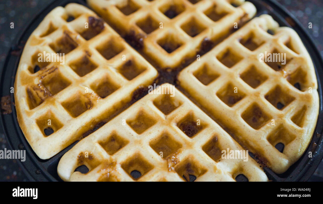 Making homemade waffles in an electric waffle maker Stock Photo Alamy