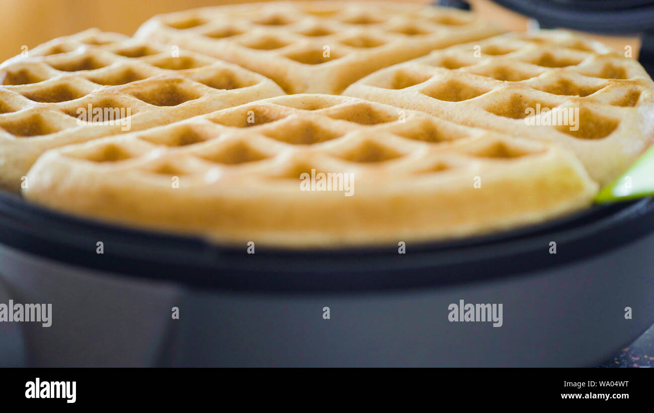 Making homemade waffles in an electric waffle maker Stock Photo Alamy