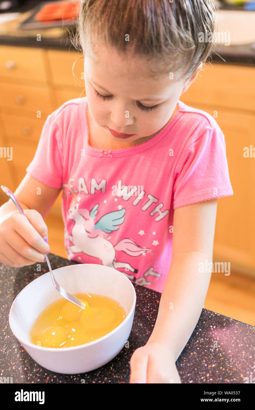 Little girl helping bake mini pound cakes in silicone molds shaped as on owls Stock Photo Alamy