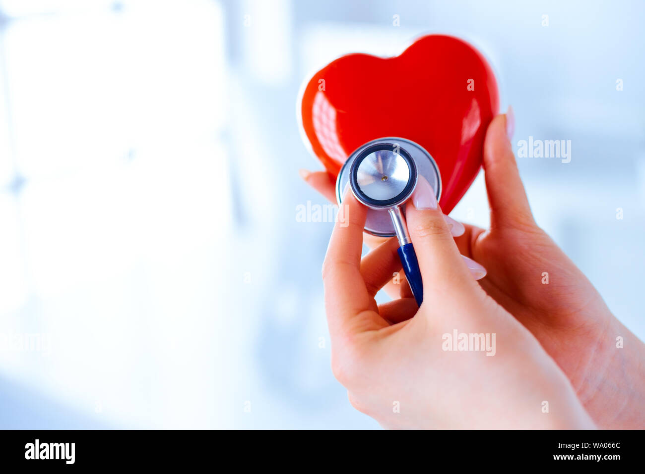 Doctor with a stethoscope examines the heart. Young doctor cardiologist ...