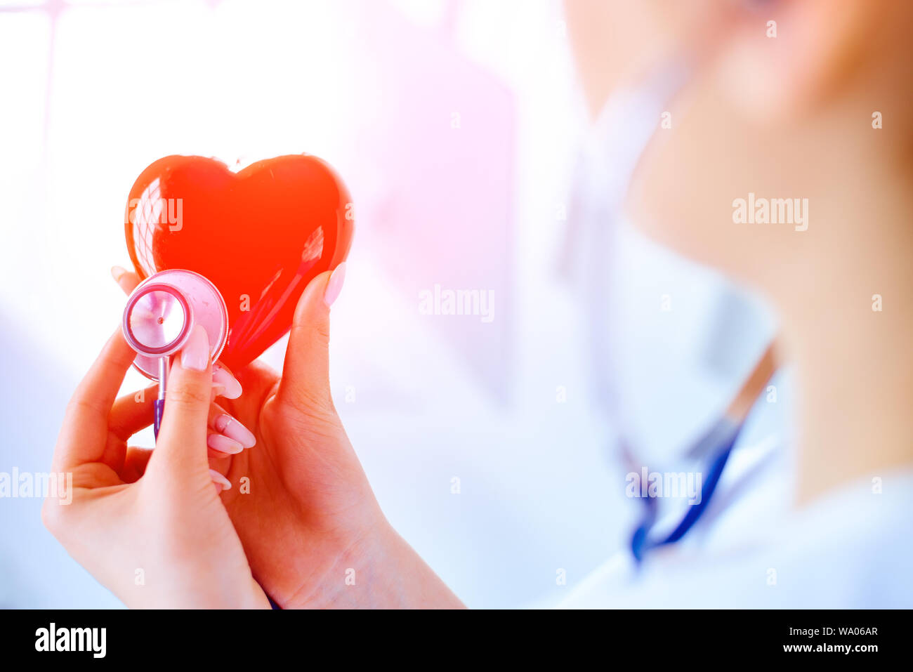 Doctor with a stethoscope examines the heart. Young doctor cardiologist ...