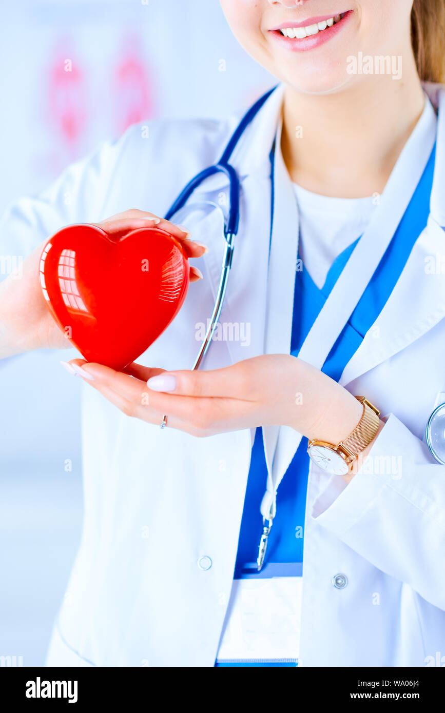 Female doctor with stethoscope holding heart, on light background. Health,  medicine, people and cardiology concept Stock Photo - Alamy