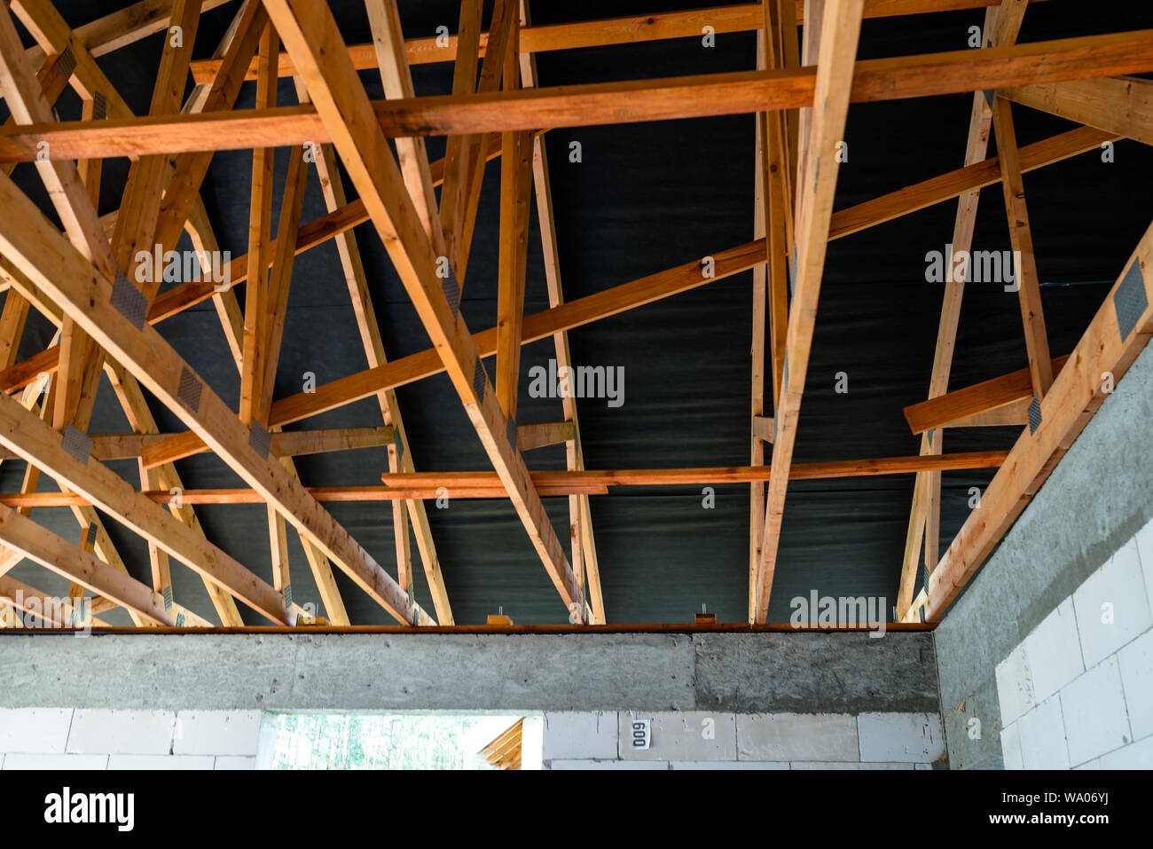 Roof Trusses Covered With A Membrane On A Detached House Under Roof Trusses Covered With A Membrane On A Detached House Under