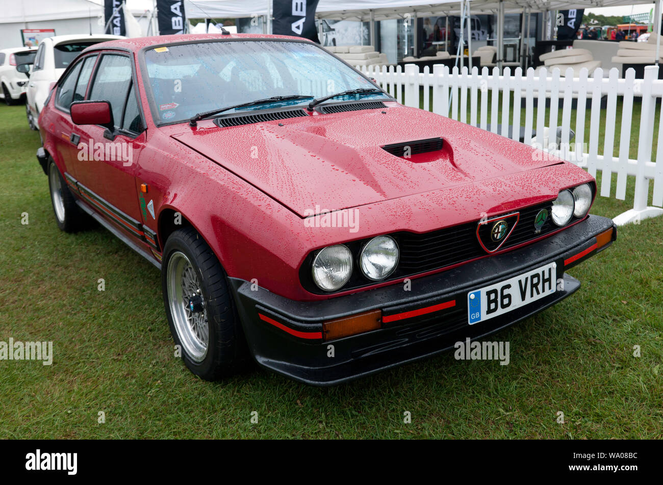 Three-quarter front  view of a Red 1984,  Alfa Romeo GTV 6  on display in the Alfa Romeo Owners Club Zone, at the 2019 Silverstone Classic Stock Photo