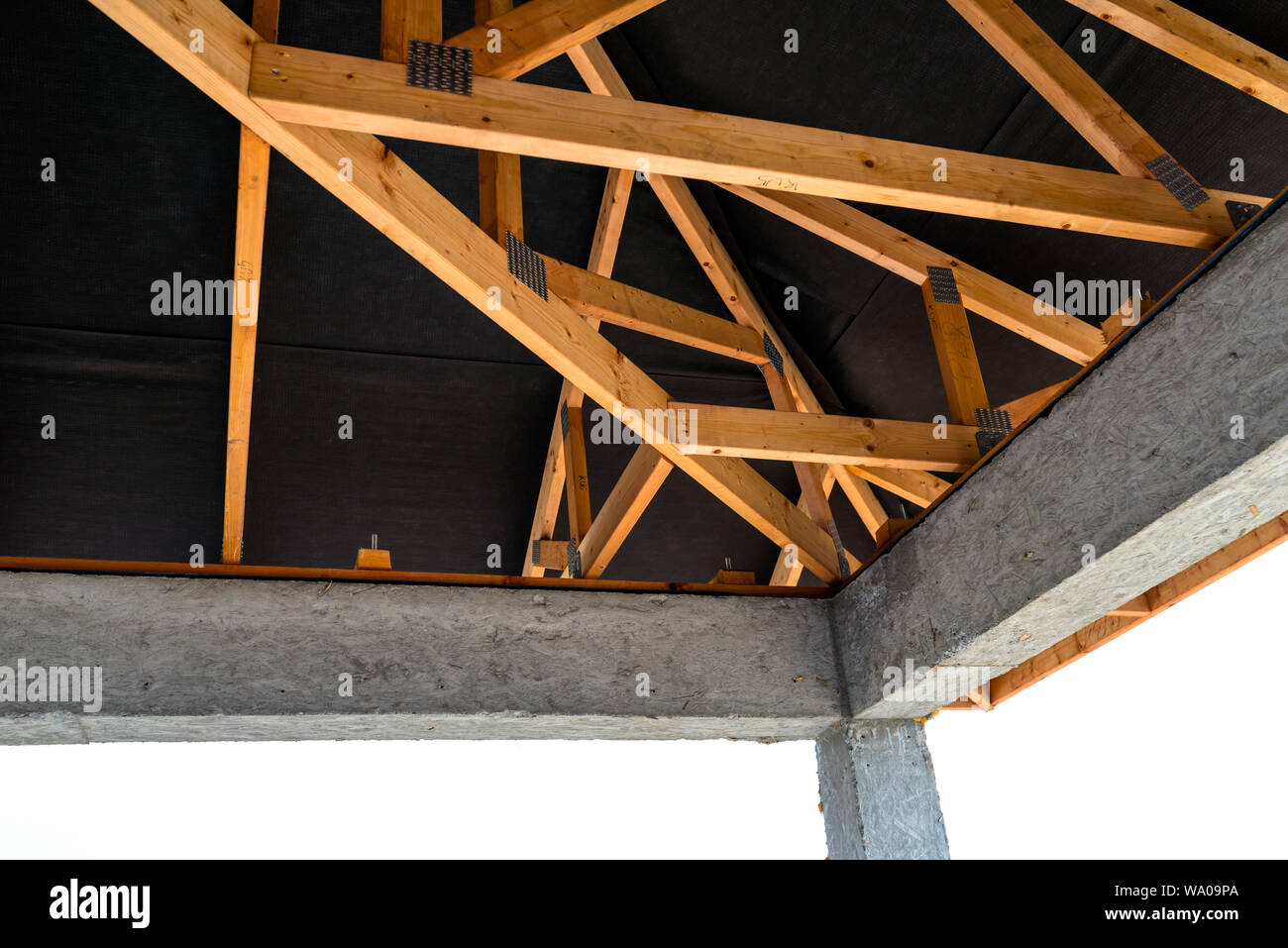 Roof Trusses Covered With A Membrane On A Detached House Under Roof Trusses Covered With A Membrane On A Detached House Under