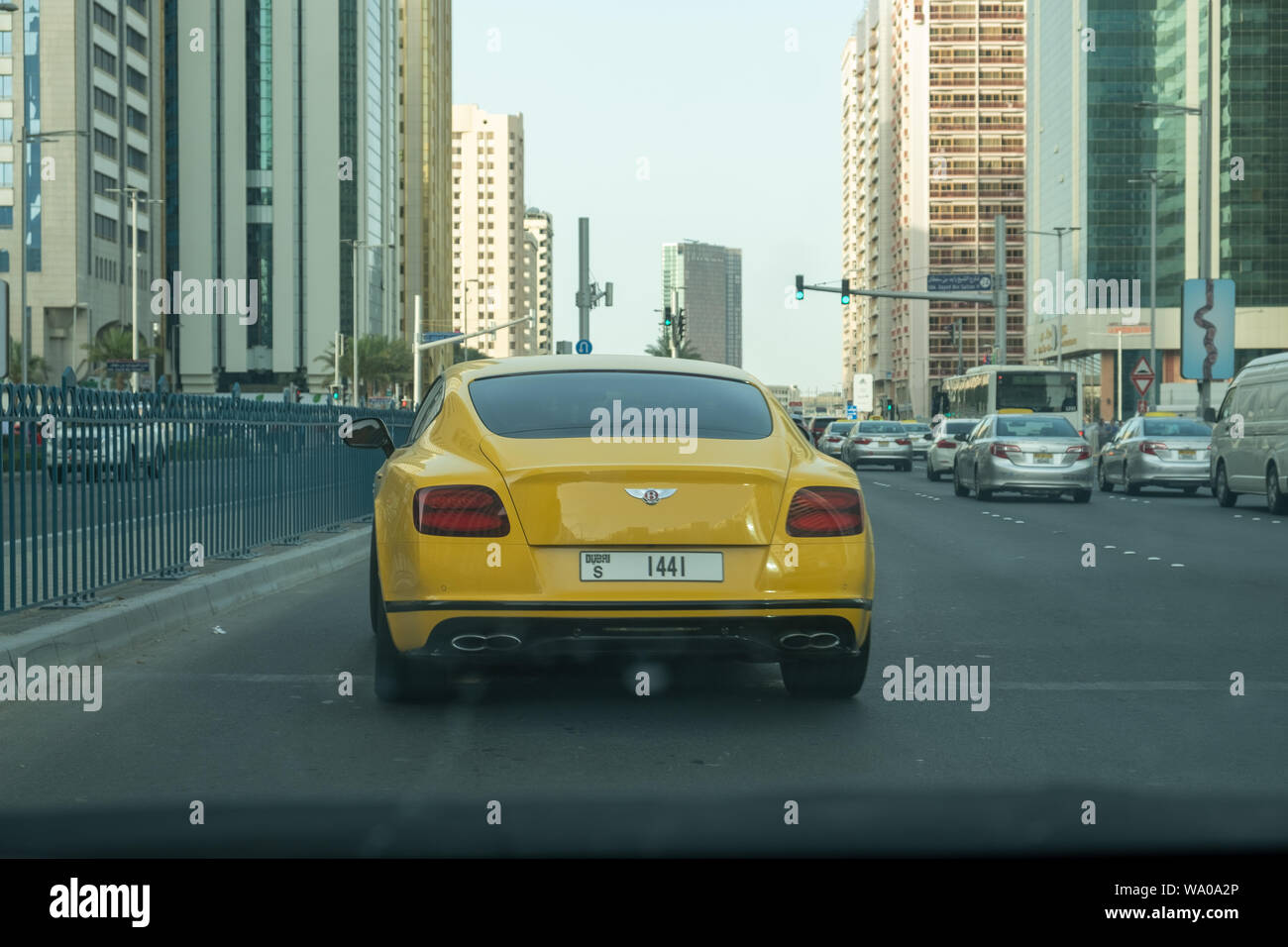 Dubai Number Plate Yellow color Bentley on Airport Road, Abu Dhabi. Stock Photo