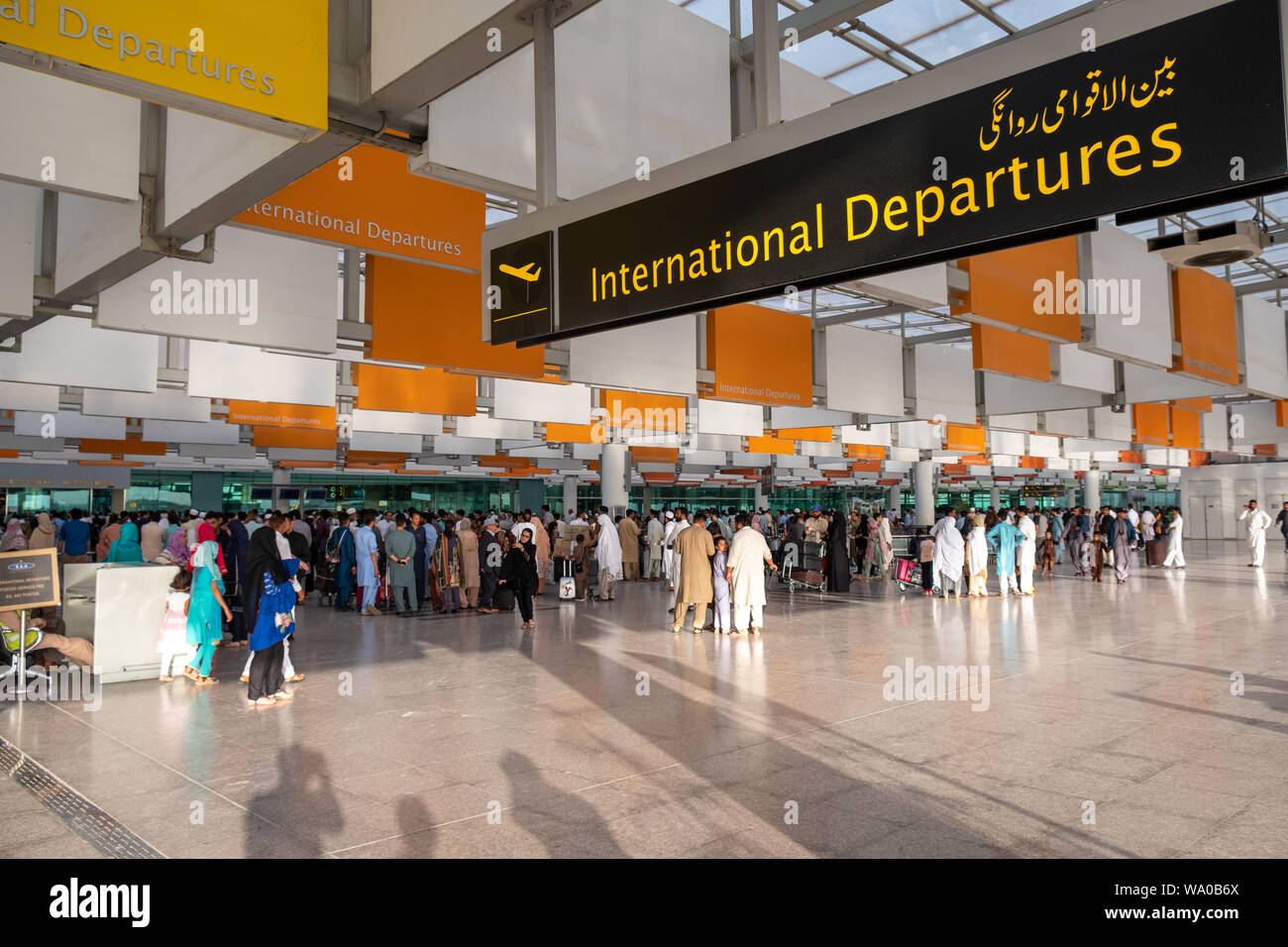 Travelers at International Departure area of  Islamabad International Airport, Pakistan. Stock Photo