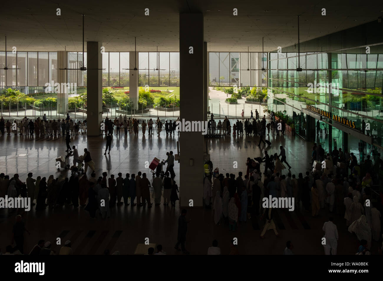 Silhouette of Travelers at International Arrivals lounge area of  Islamabad International Airport, Pakistan. Stock Photo