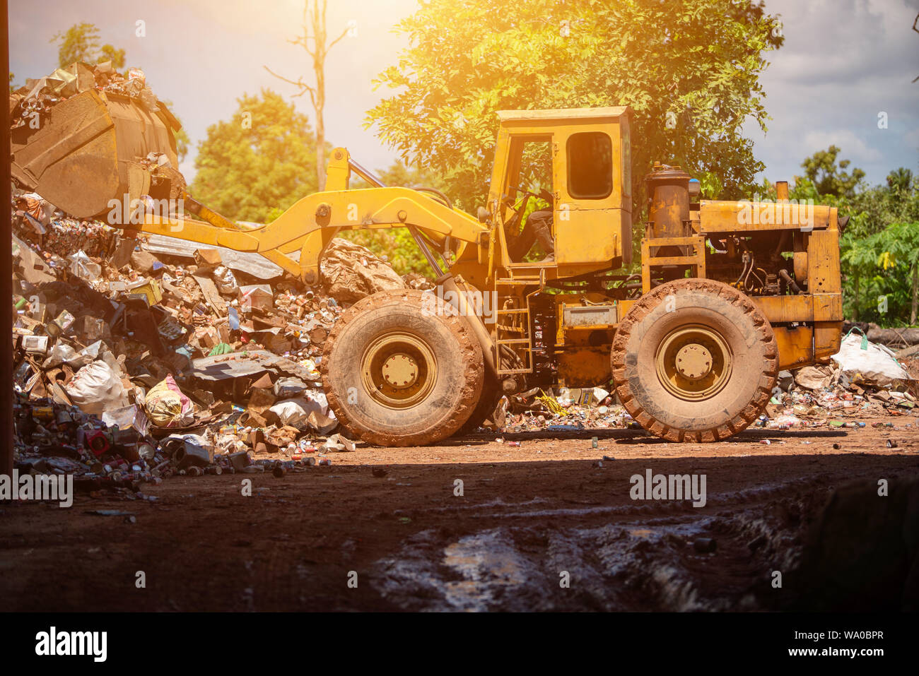 Recycling waste management in the factory with a tractor Stock Photo