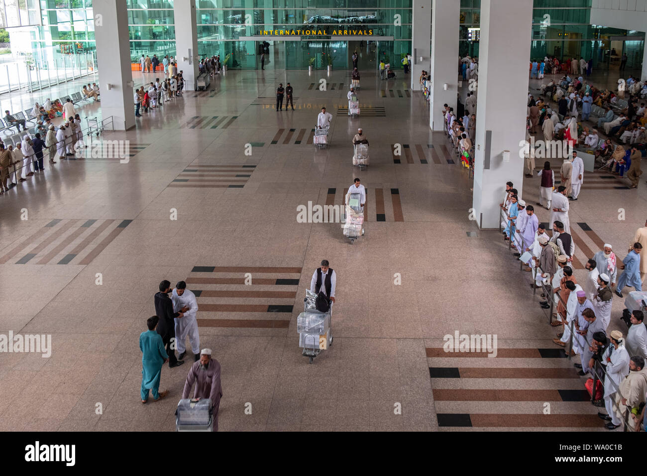 Travelers at International Arrivals lounge area of  Islamabad International Airport, Pakistan. Stock Photo