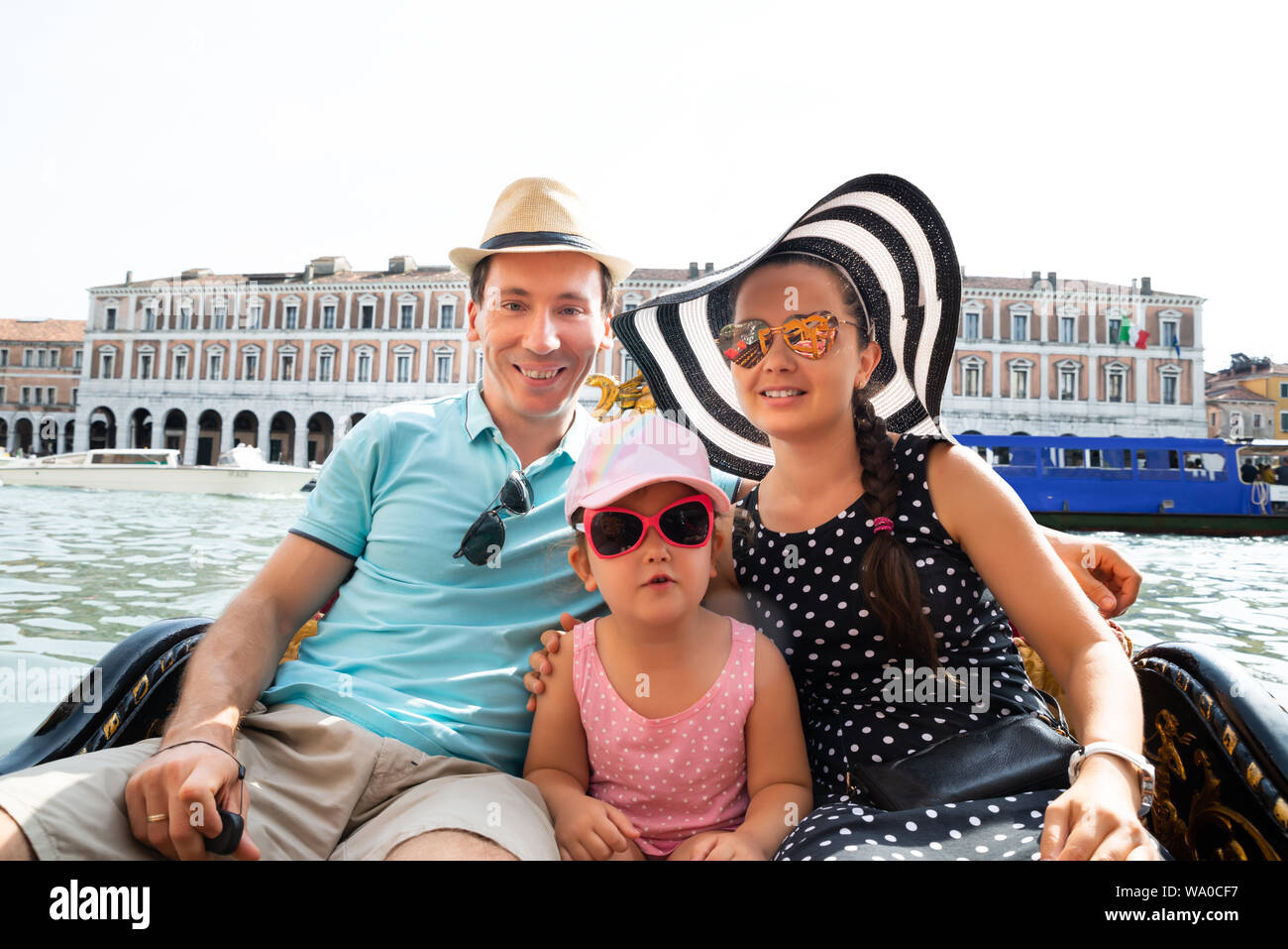 Happy Family On Vacation Sailing In Gondola, Venice Stock Photo
