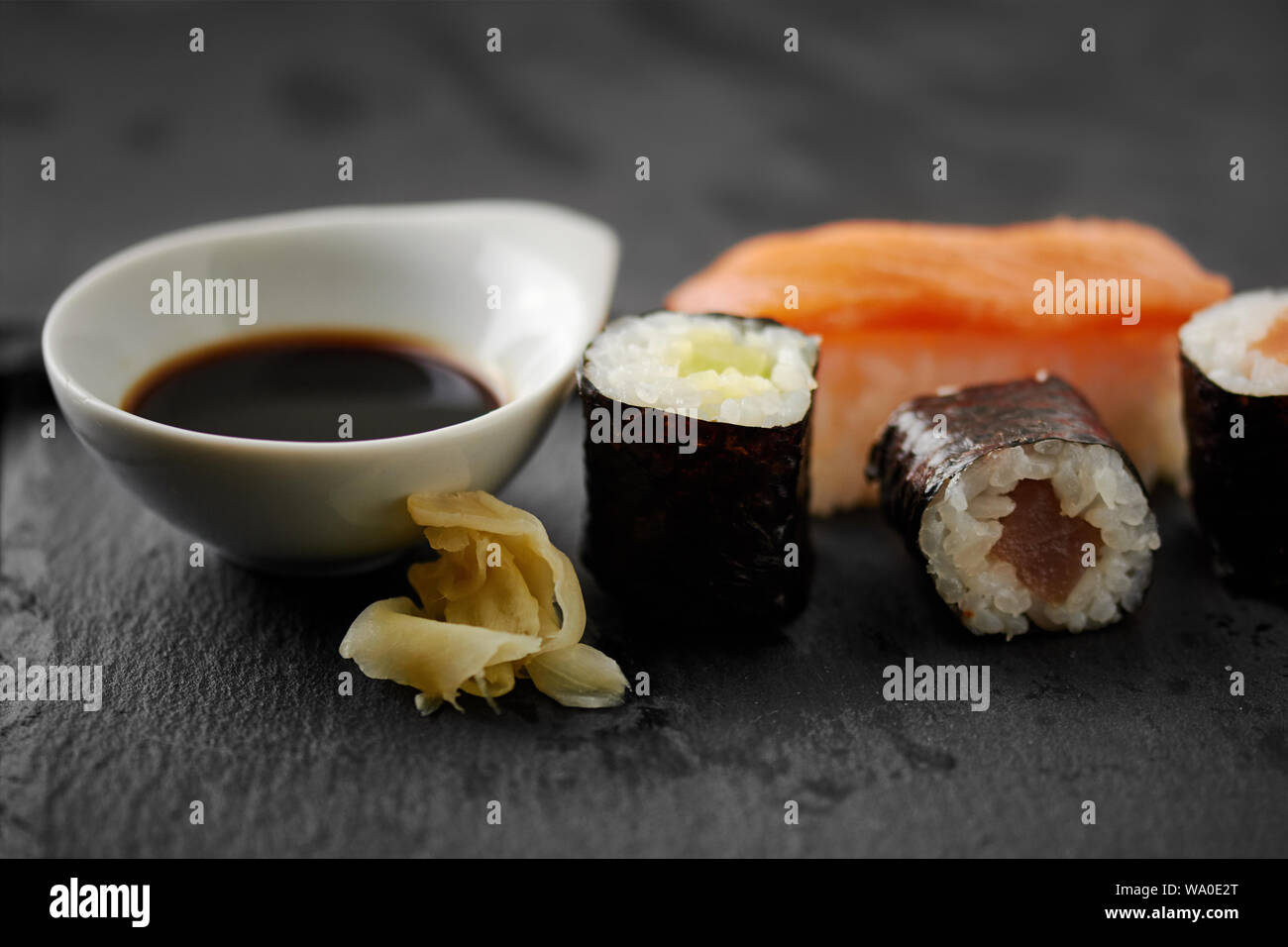 Japanese Sushi Set With Salmon Fish Avocado And Soy Sauce On A Black Stone Background Stock Photo Alamy