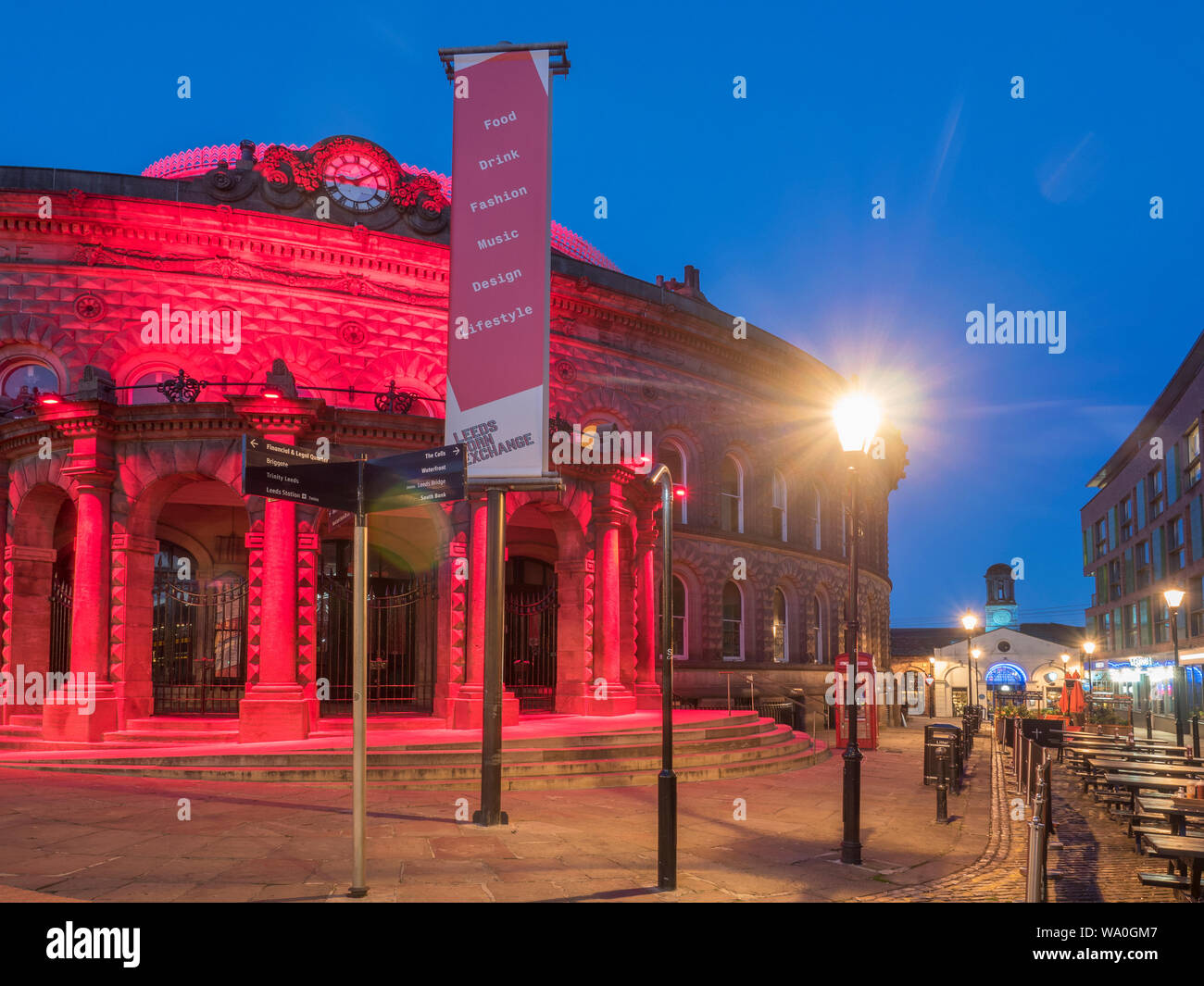 The Corn Exchange illuminated by red lights at dusk Leeds West Yorkshire England Stock Photo
