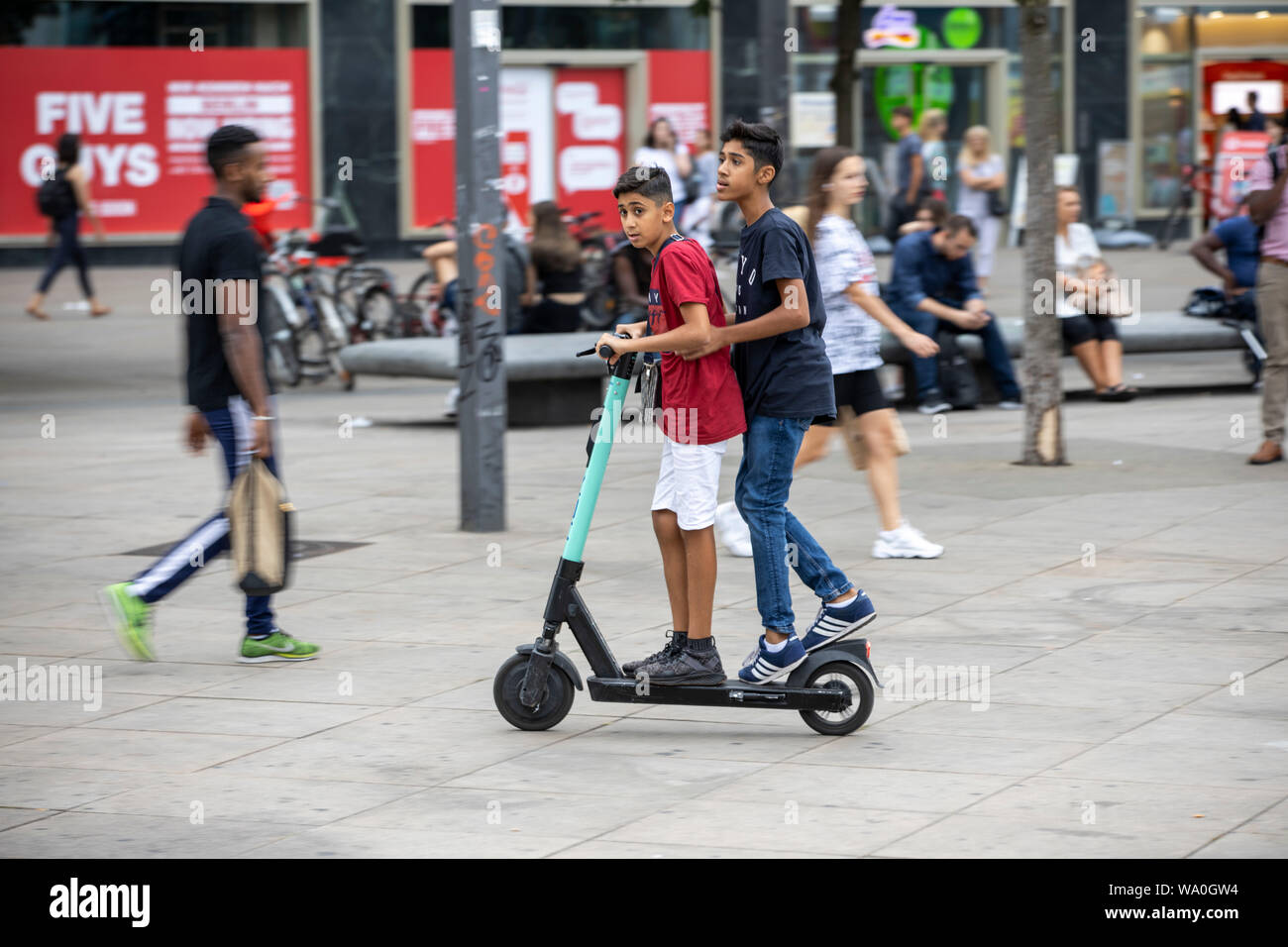 E-scooter, electric scooter, rental scooter, driving, at Alexander Platz,  in Berlin, tow people on one scooter Stock Photo - Alamy