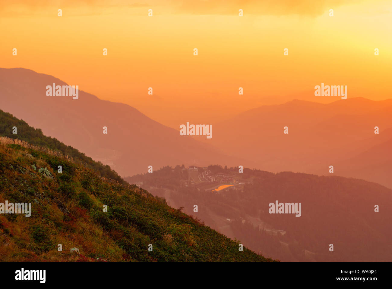 view of a beautiful mountain valley with a small town in the sunrise ...