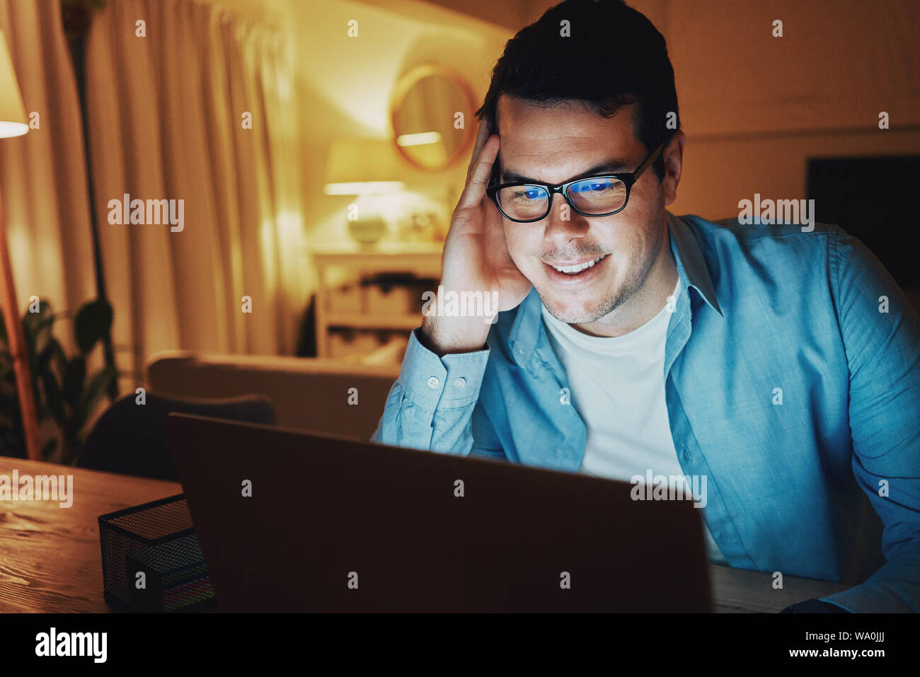 Cheerful man internet addict man using laptop Stock Photo