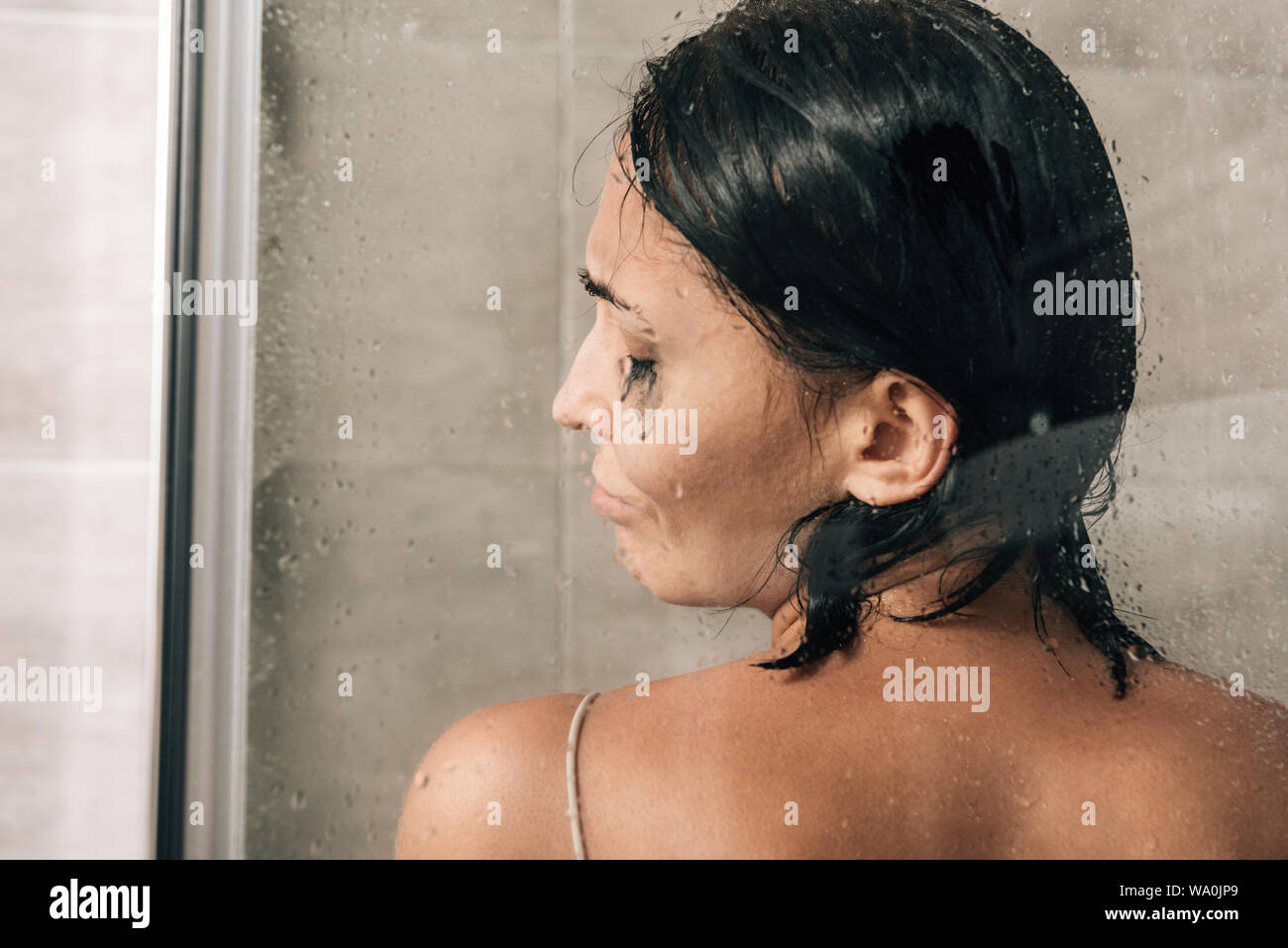 back view of lonely depressed woman in shower at home Stock Photo Alamy