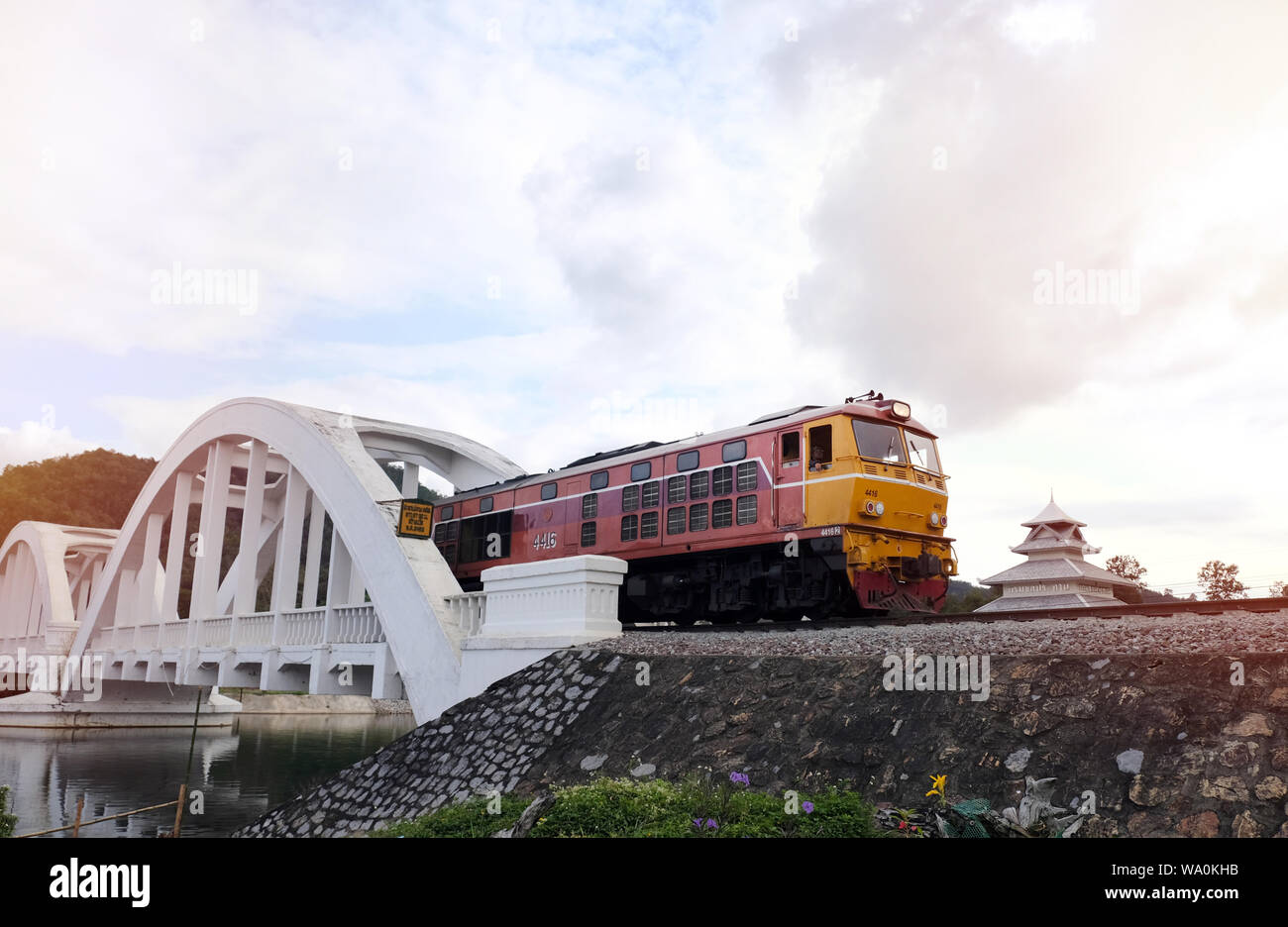 Old diesel train Running on the bridge over the white bridge The famous steel bridge in Lampoon, Thailand Stock Photo