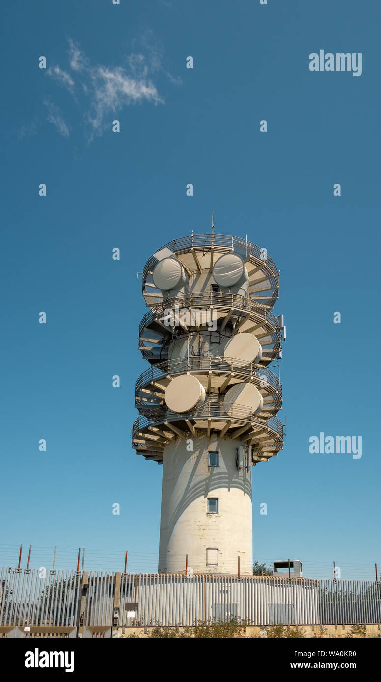 Telecommunication tower against a blue sky. Stock Photo