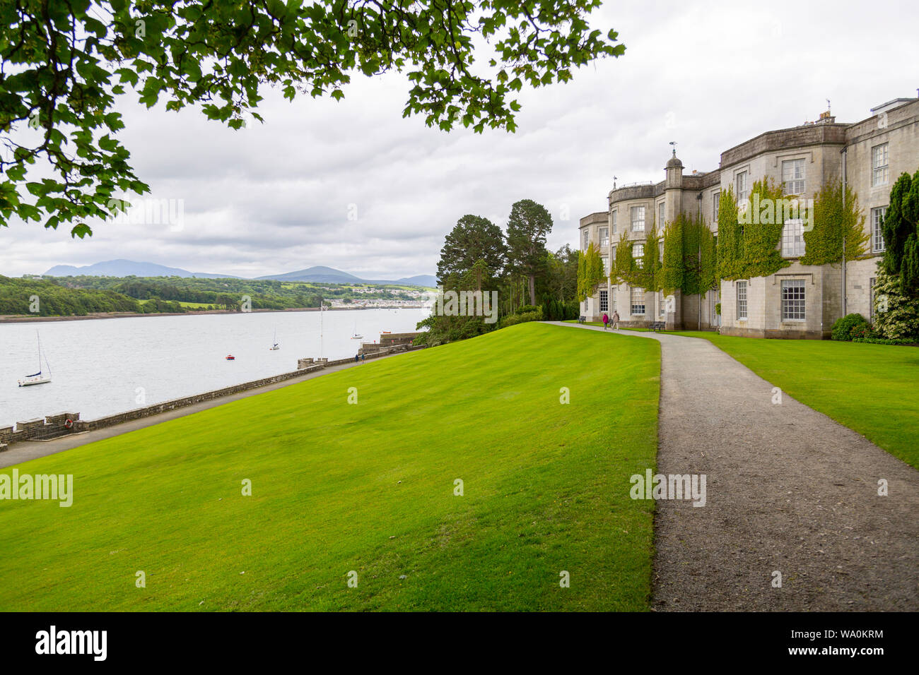 The imposing country house of Plas Newydd sits on the banks of the Menai Straits, Anglesey, Wales, UK Stock Photo