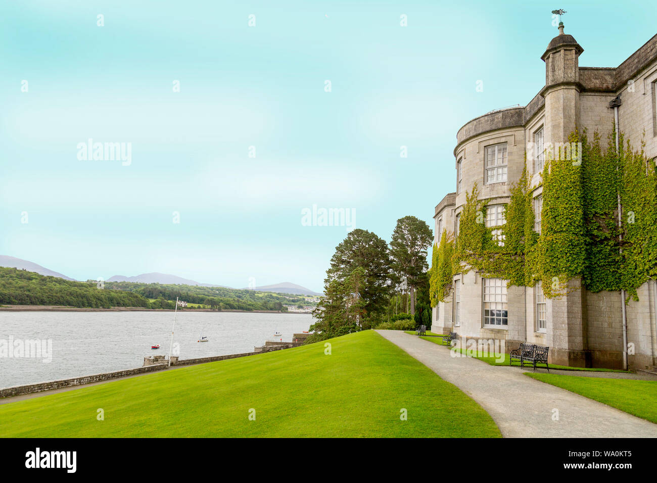 The imposing country house of Plas Newydd sits on the banks of the Menai Straits, Anglesey, Wales, UK Stock Photo