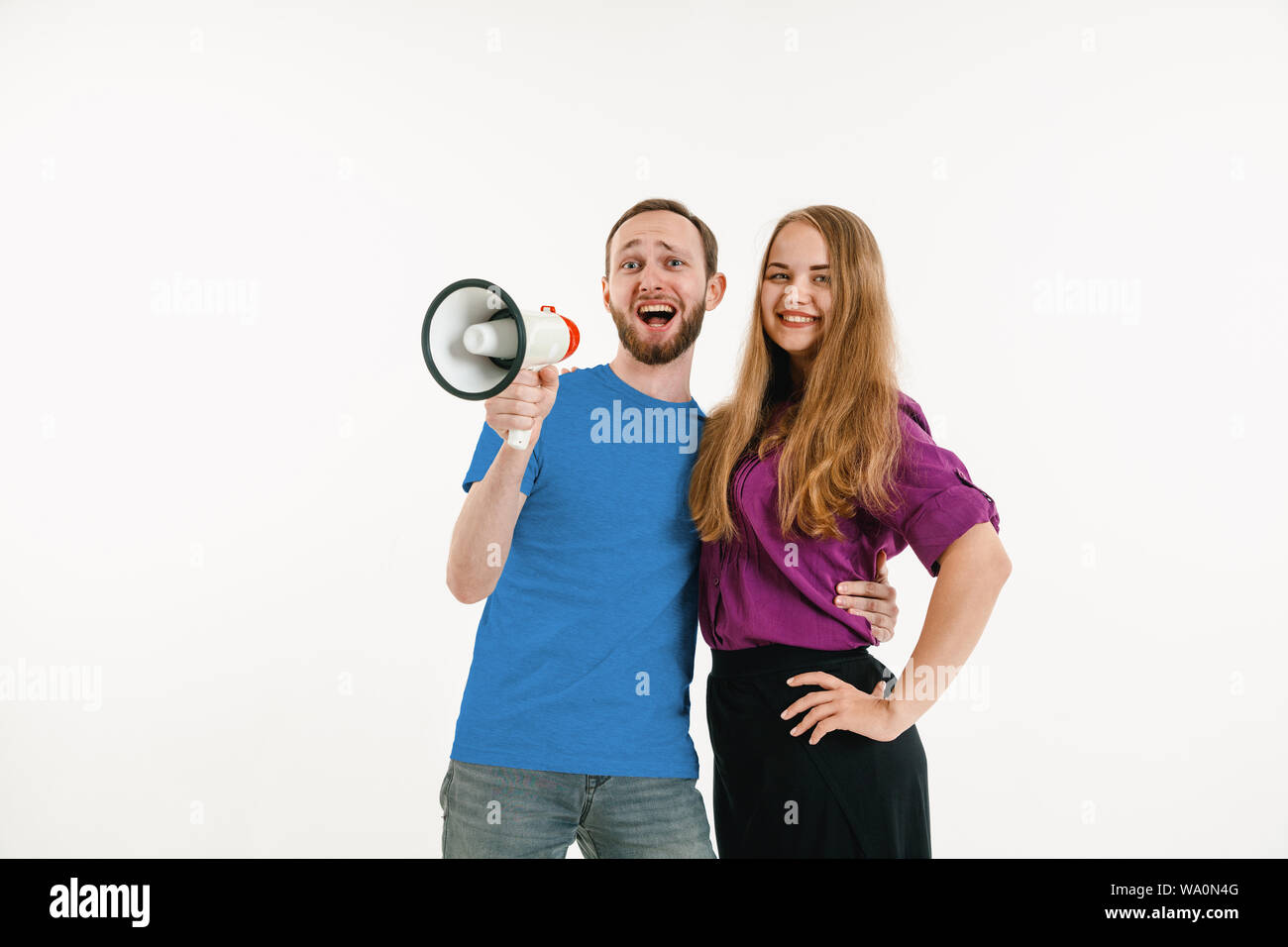 Young man and woman weared in LGBT flag colors on white background ...