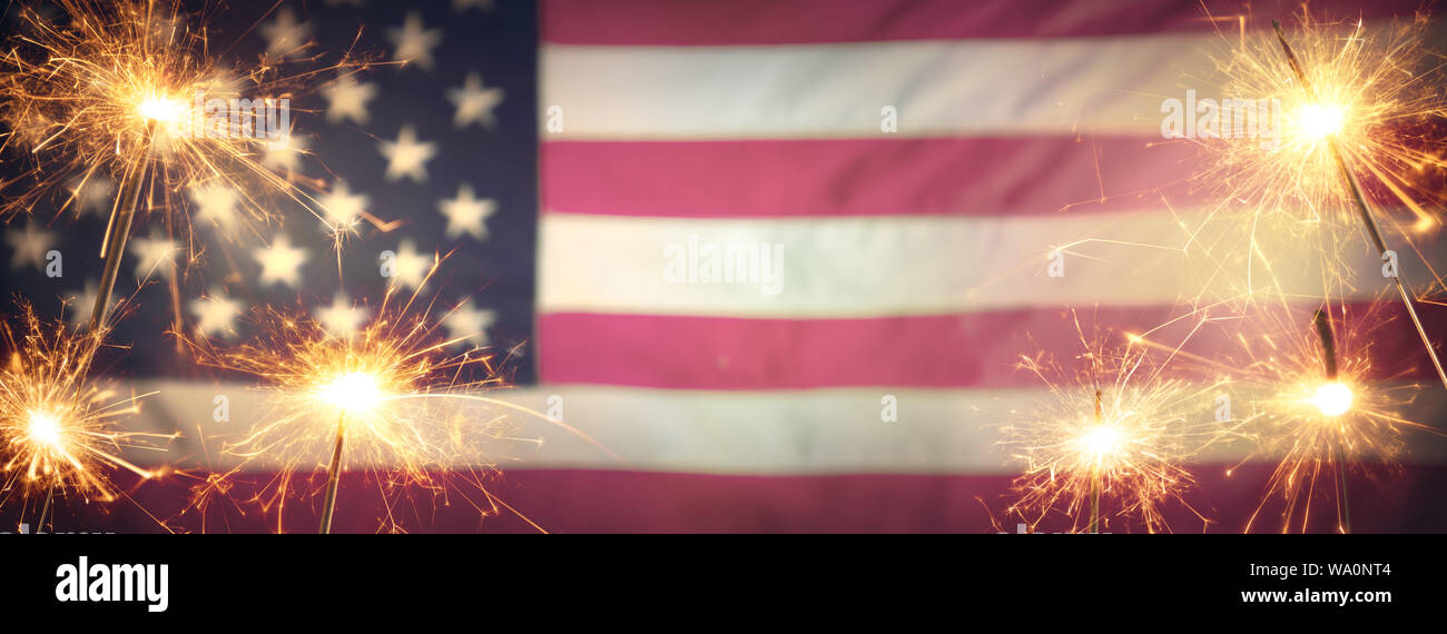 Vintage Celebration With Sparklers And Defocused American Flag - 4th Of July Stock Photo