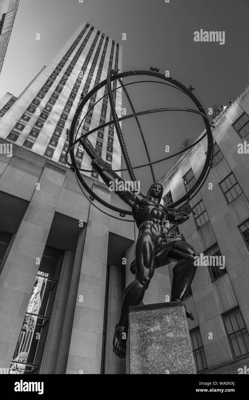 A black and white picture of the Atlas Statue in front of a Rockefeller Center building. Stock Photo