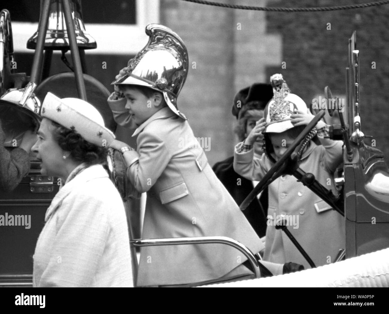 Queen Elizabeth II, Princess Diana, Prince William, Prince Harry, on a vintage fire engine at Sandringham. Stock Photo