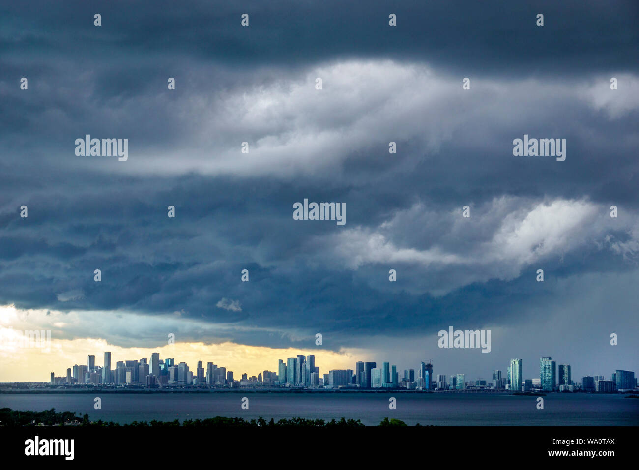 Miami Beach Florida,dark clouds weather sky storm clouds gathering,rain,city skyline,Biscayne Bay,FL190731008 Stock Photo