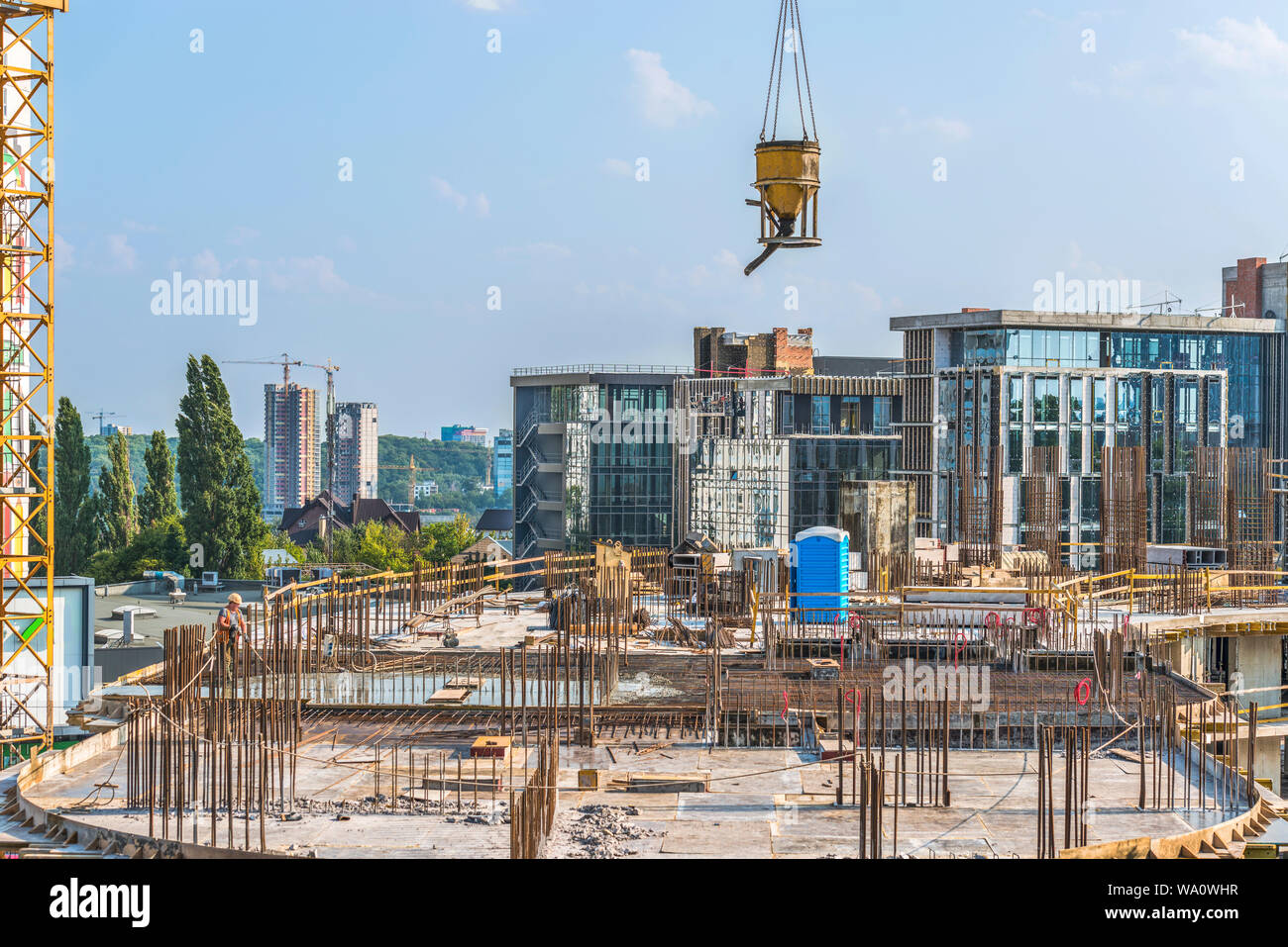 New building under construction and construction site of a residential building. Concrete work is being performed at the site. Stock Photo