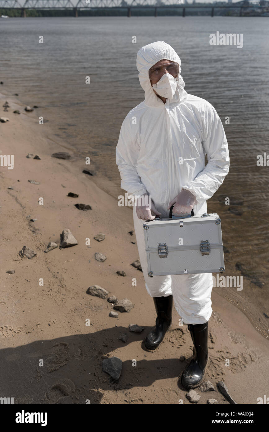 Water Inspector full length view of water inspector in protective costume, respirator ...