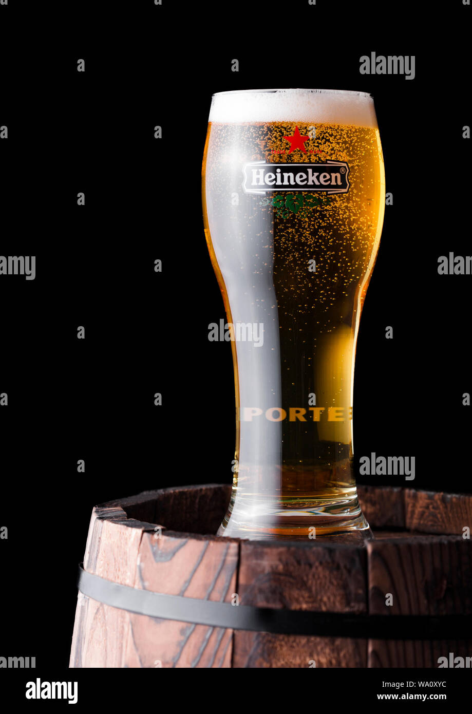 LONDON, UK APRIL 27, 2018 Bottle and original glass of Heineken Lager Beer on top of old