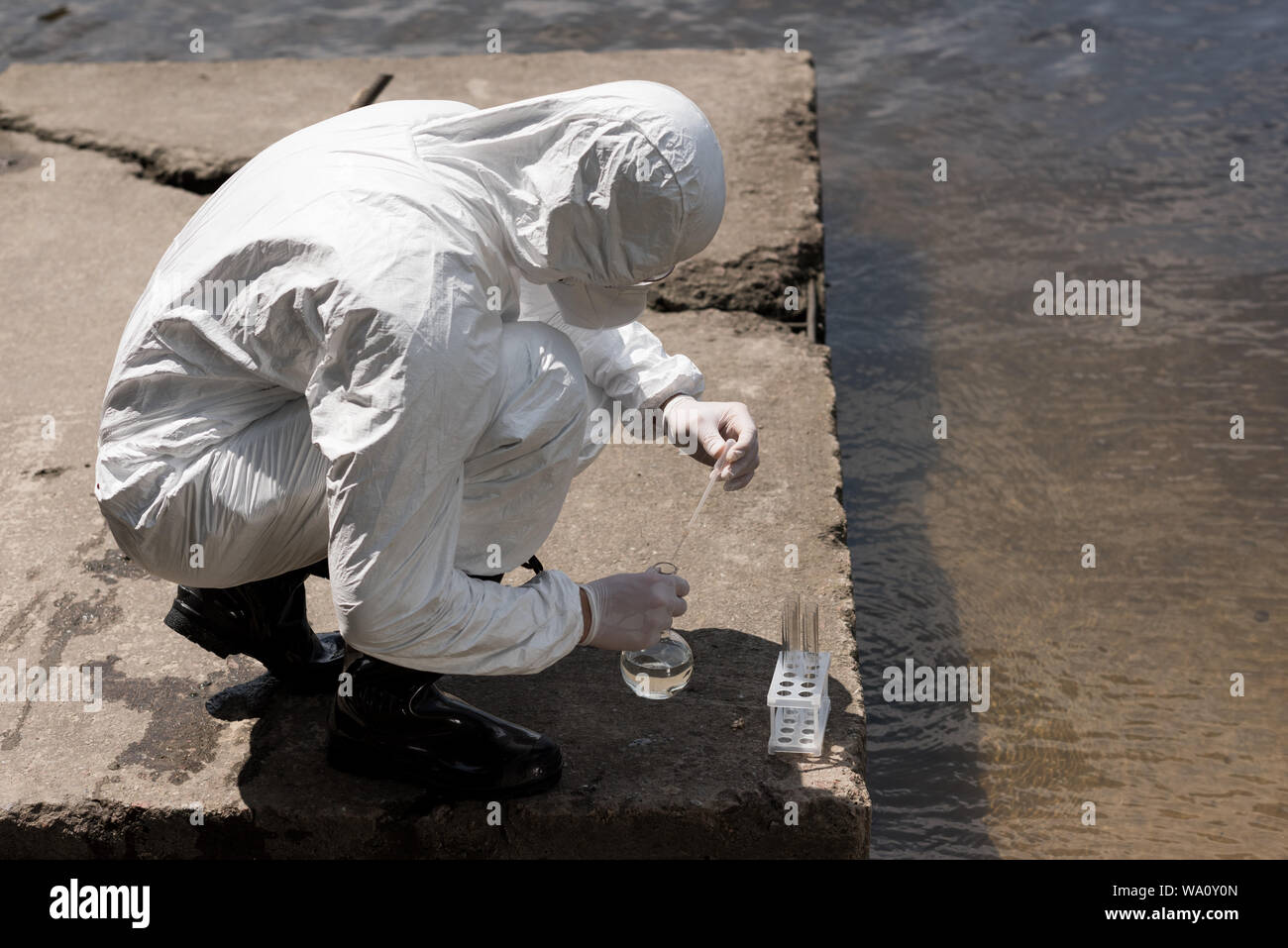 Water Inspector water inspector in protective costume, latex gloves and respirator ...