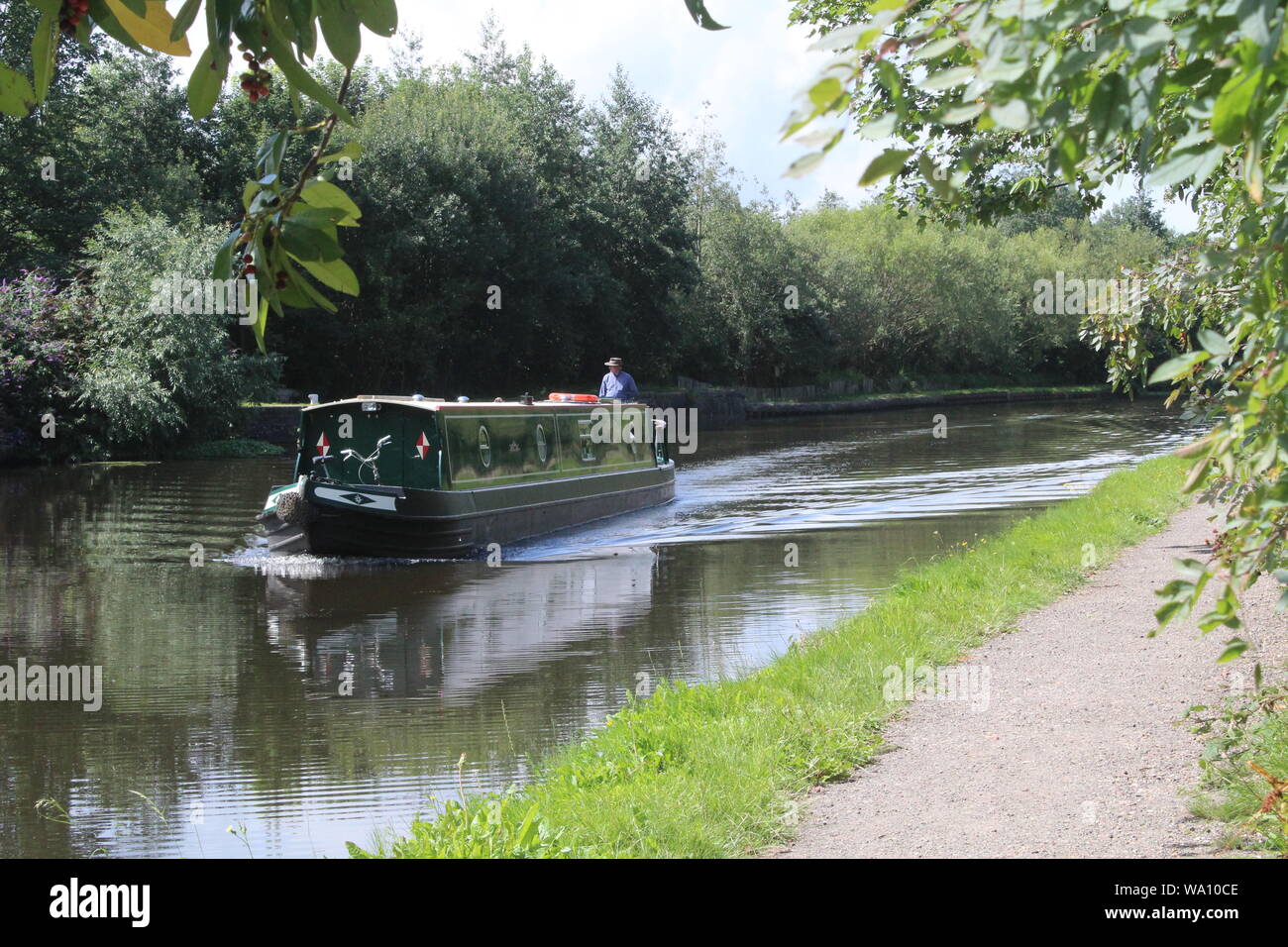 Narrow boat cruising along the Aire and Calder Navigation a canal in Narrow boat cruising along the Aire and Calder Navigation a canal in